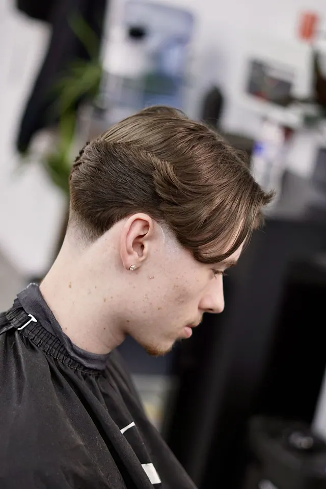 A textured side part with a low taper